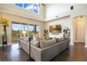 Spacious living room with soaring ceilings, large windows offering scenic views, and a comfortable seating area at 16410 Good Hearth Blvd, Clermont, FL 34711