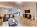Open-concept living room and kitchen, complete with modern furnishings, sleek appliances, and lots of natural light at 17081 Water Spring Blvd, Winter Garden, FL 34787