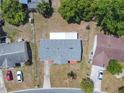 Birds eye view of single-story home with a grey roof and fenced-in backyard with a storage shed at 186 Tulpan Dr, Kissimmee, FL 34743