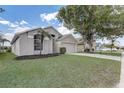 Single-Gathering home showcasing a well-kept lawn, mulch beds, and a spacious driveway leading to a garage at 19540 Glen Elm Way, Orlando, FL 32833