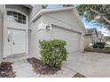 Attached two-car garage providing ample parking and storage, adjacent to the inviting front entrance at 19540 Glen Elm Way, Orlando, FL 32833