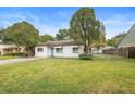 Attractive home showcasing a neat lawn, classic white exterior, and established trees at 2123 Weber St, Orlando, FL 32803