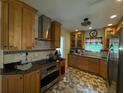 Updated kitchen with granite countertops, stainless steel appliances, and custom cabinetry at 2123 Weber St, Orlando, FL 32803