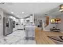 Bright open kitchen featuring a large island, stainless steel appliances, and a stylish marble floor at 2447 Hassonite St, Kissimmee, FL 34744