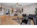 Cozy living room with hardwood floors, contemporary furnishings and decor, and a ceiling fan at 2447 Hassonite St, Kissimmee, FL 34744