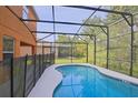 Screened-in pool offers private relaxation with a manicured lawn and plenty of sunlight at 2660 Santosh Cv, Kissimmee, FL 34746