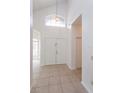 Bright foyer featuring tile flooring, a high ceiling, and a double front door at 2903 Joseph Cir, Oviedo, FL 32765