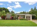 Charming single-story home featuring lush green lawn and mature landscaping at 2918 Wessex St, Orlando, FL 32803