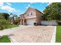 Two-story home with a spacious driveway and well-maintained front yard at 294 Hunt St, Clermont, FL 34711