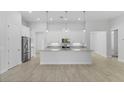 Bright, open kitchen with large island, modern appliances, and tile flooring at 371 Miller Rd, Sanford, FL 32773