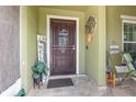 Inviting front porch featuring decorative accents, tiled flooring and a seating area at 3842 Klondike Pl, Sanford, FL 32771