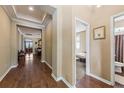 Hallway with hardwood floors and crown molding leading to bedroom and other rooms at 4813 River Gem Ave, Windermere, FL 34786