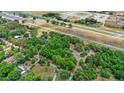 Beautiful birds-eye view showing property lines, lush greenery, and serene location next to a speedway at 549 Wellon Ave, Orlando, FL 32833
