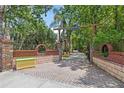 Long private driveway with brick columns, lush trees, and sign on entrance at 549 Wellon Ave, Orlando, FL 32833