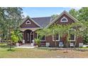 Inviting front exterior featuring a manicured lawn, mature trees, and a covered front porch at 549 Wellon Ave, Orlando, FL 32833