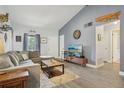 Comfortable living room with a modern TV, blue accent wall, and ample seating space at 620 Fruitwood Ave, Winter Springs, FL 32708