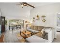 Spacious living room with vaulted ceilings, wood beams, and neutral tones creating a warm atmosphere at 620 Fruitwood Ave, Winter Springs, FL 32708