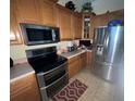 Modern kitchen with stainless steel appliances and neutral countertops at 6438 Bristol Oaks Dr, Lakeland, FL 33811