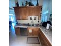 Functional kitchen with stainless steel sink and wooden cabinets providing ample storage at 6438 Bristol Oaks Dr, Lakeland, FL 33811