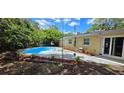 Private backyard with in-ground pool, patio space, and lush landscaping at 7600 Skyview Dr, Orlando, FL 32809