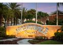 Illuminated Margaritaville Resort sign surrounded by palm trees and tropical foliage at 8045 Lost Shaker Ln, Kissimmee, FL 34747