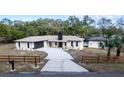 Beautiful house with a well-maintained lawn and fence surrounding the property at 817 Helen Ave, Deland, FL 32720