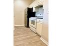 The kitchen features stainless steel refrigerator, white cabinetry and oven at 860 N Orange Ave # 371, Orlando, FL 32801