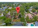 Aerial view of the home nestled among mature trees with a large, fenced backyard at 913 Moss Ln, Winter Park, FL 32789