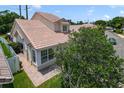 A charming home featuring a tile roof, mature landscaping, and well-manicured lawn at 939 Glen Abbey Cir, Winter Springs, FL 32708