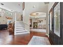 Grand foyer with soaring ceilings, hardwood floors, staircase, and chandelier, creating an inviting entry at 108 Sagecrest Dr, Ocoee, FL 34761