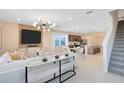 Bright and airy living space featuring modern lighting and staircase access at 11328 Blue Bay Dr, Orlando, FL 32832
