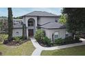Charming two-story home with a well-manicured lawn and inviting front entrance at 11994 Mckinnon Rd, Windermere, FL 34786