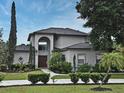 Charming two-story home with a well-manicured lawn and inviting front entrance at 11994 Mckinnon Rd, Windermere, FL 34786