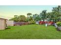 Spacious backyard with a full privacy fence and green lawn perfect for outdoor activities at 12381 Antonio Cir, Orlando, FL 32826