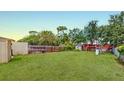 Spacious backyard with a full privacy fence and green lawn perfect for outdoor activities at 12381 Antonio Cir, Orlando, FL 32826