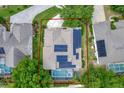 Aerial view of a single Gathering home with a large backyard pool and solar panels on the roof at 12411 Scarlett Sage Ct, Winter Garden, FL 34787