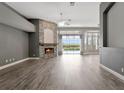 Spacious living room with fireplace, hardwood floors, and sliding glass doors to the pool at 12411 Scarlett Sage Ct, Winter Garden, FL 34787