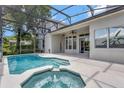 Beautiful screened-in pool and hot tub area featuring an outdoor ceiling fan at 12411 Scarlett Sage Ct, Winter Garden, FL 34787