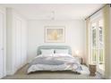 Bright, minimalist bedroom with a modern bed, a ceiling fan, and access to a balcony with natural light at 12536 Westhaven Oak Dr # 111, Winter Garden, FL 34787