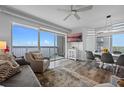 Bright living room with large sliding glass doors to balcony overlooking scenic views, and modern furnishings at 13415 Blue Heron Beach Dr # 710, Orlando, FL 32821