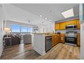 Living room seamlessly flows into kitchen with stainless steel appliances, wood cabinetry and a scenic view at 13415 Blue Heron Beach Dr # 710, Orlando, FL 32821