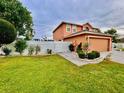 Side view of a two-story home with a white fence and manicured landscaping at 16041 Lagoon Dr, Clermont, FL 34711
