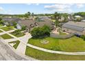 Suburban neighborhood street view with well-maintained lawns, mature trees, and a charming single-Gathering home at 219 Old Mill Cir, Kissimmee, FL 34746