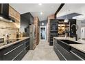 Modern kitchen with stainless steel appliances, granite countertops, and sleek cabinetry at 219 Old Mill Cir, Kissimmee, FL 34746