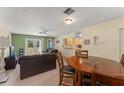 Open living space featuring a living room, dining area, and a glimpse of the kitchen at 225 Indiana St, Leesburg, FL 34748