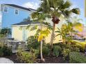 Backyard with a patio table, chairs, and tropical landscaping for outdoor relaxation and privacy at 3013 Latitude Ln, Kissimmee, FL 34747