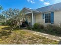 Charming home featuring a covered front porch with seating area at 3123 Tamarind Dr, Edgewater, FL 32141