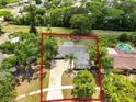 Aerial view of the home with green lawn and large trees at 3520 Balsam Dr, Winter Park, FL 32792