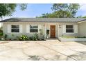 Charming single-story home features a well-manicured front yard and a welcoming entrance at 3520 Balsam Dr, Winter Park, FL 32792