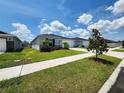 Quaint single-story home with well-manicured lawn and inviting curb appeal on a sunny day at 3838 Whitetail Ct, St Cloud, FL 34772